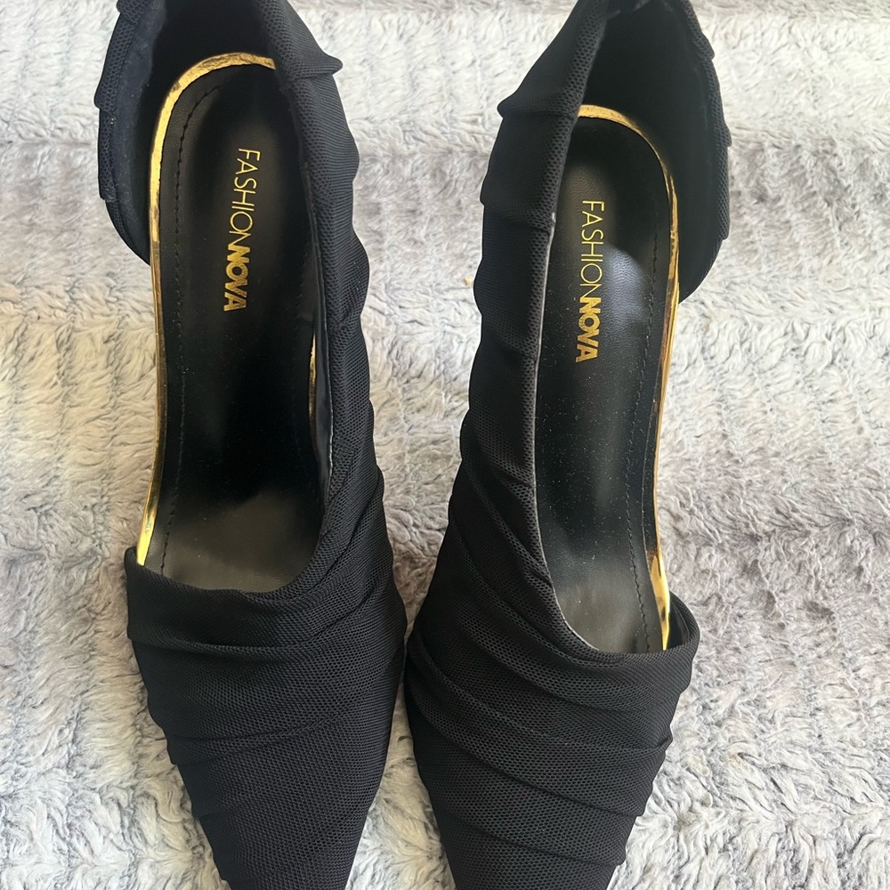 Woman’s Black Lucite heels.